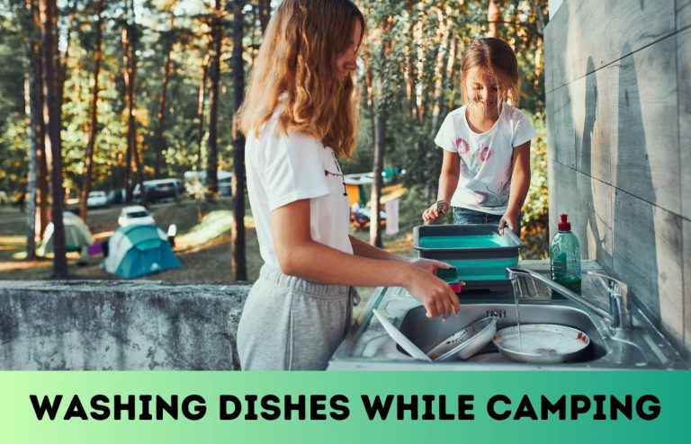 Women washing dishes at a campsite